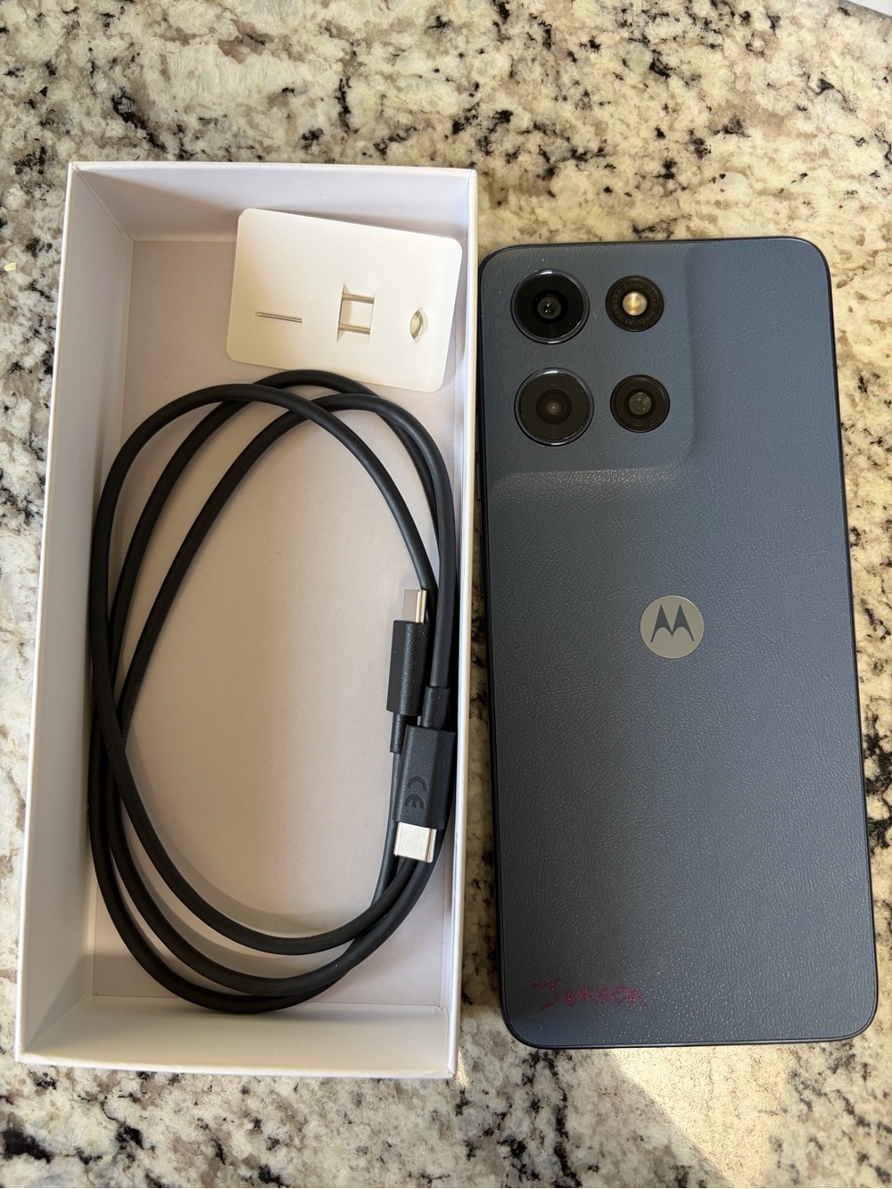Motorola Moto G 2026 cell phone and charging cable